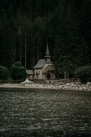 a church sitting on a small island by the water