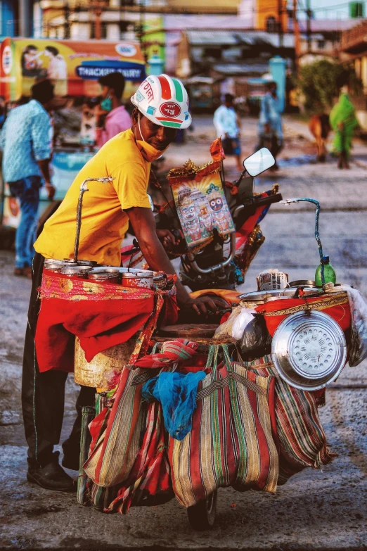 a man sits on top of a motorbike and wears a helmet