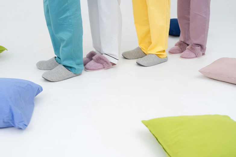 a group of people standing behind a lot of pillows