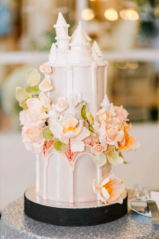 a tall white cake with some flowers on it