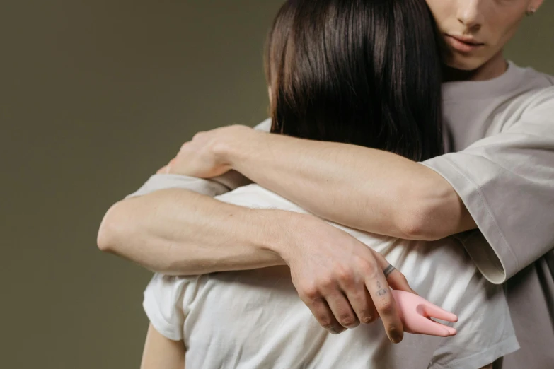 a young man and woman are touching hands