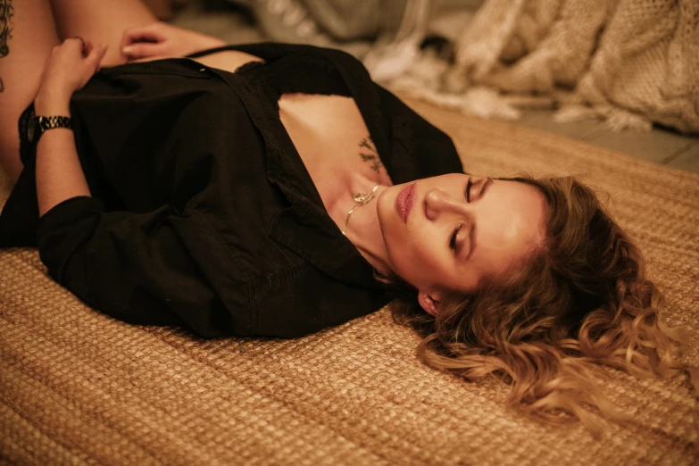 a woman lying down on her stomach with an arm on the ground