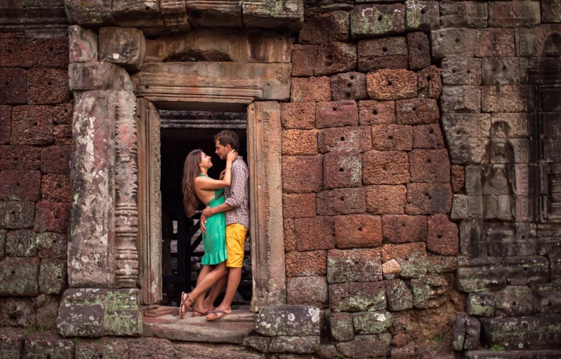 two people standing at the entrance of an old building