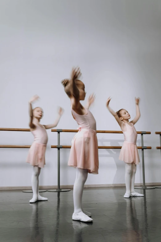 a couple of dancers standing in front of a rail