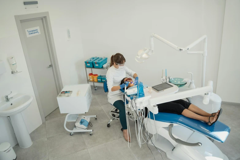 dentist taking patient's equipment while seated at the table