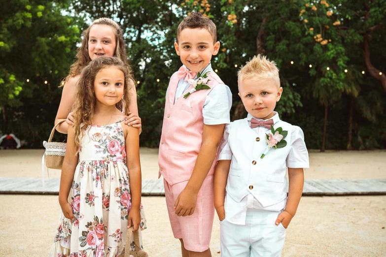 children in their wedding clothes are all lined up