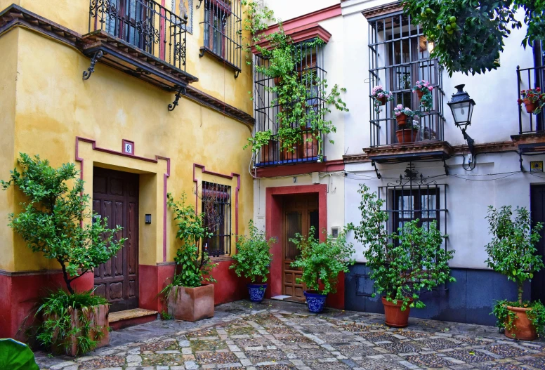 a courtyard is surrounded by yellow and red buildings
