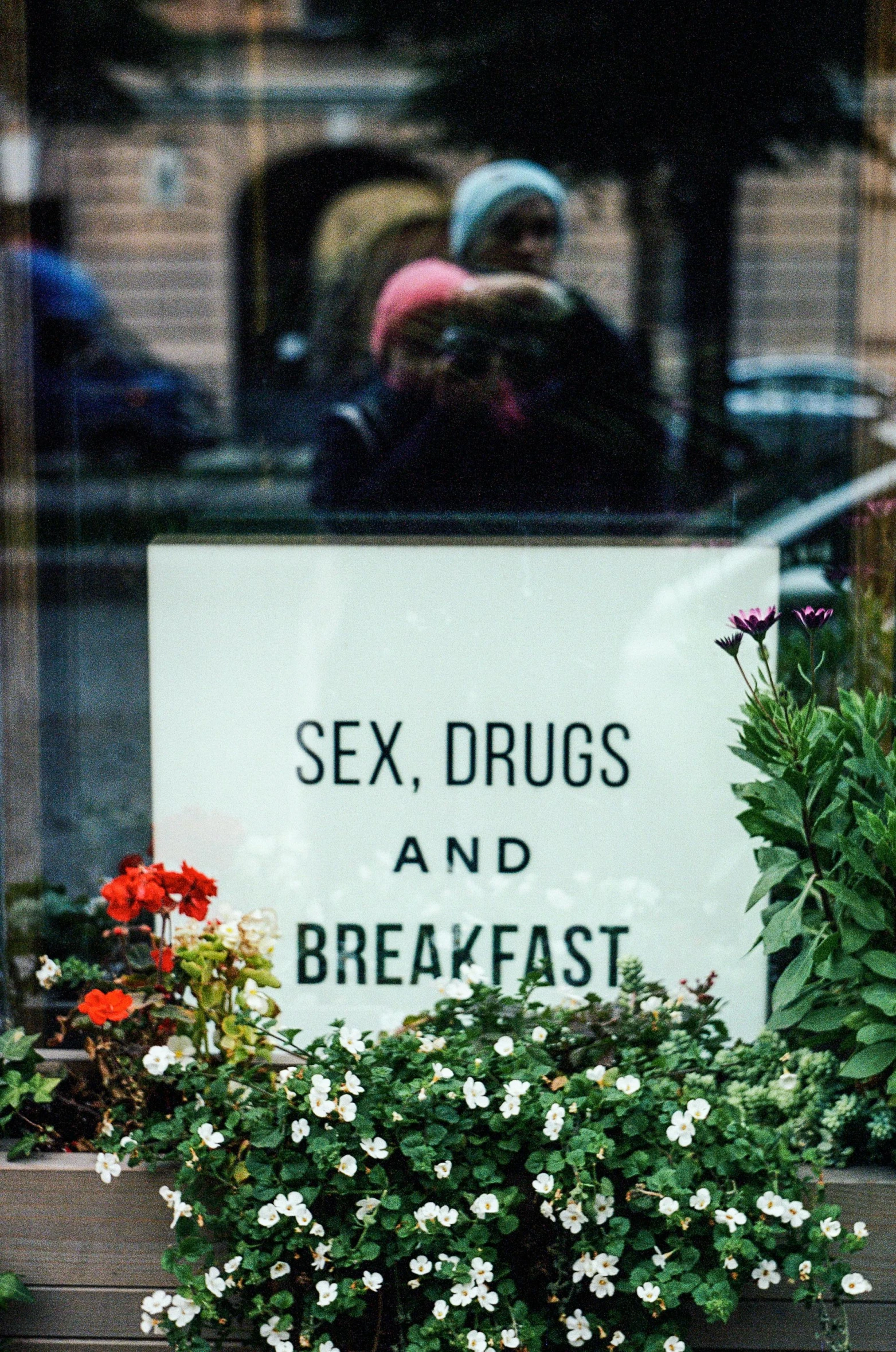 some signs saying sex  and breakfast are in a window