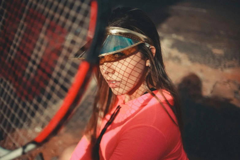 a woman holding a tennis racket on top of a hard wood floor