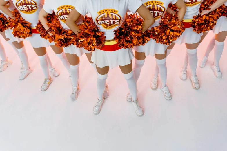 a group of people that are in front of some pink and orange decorations