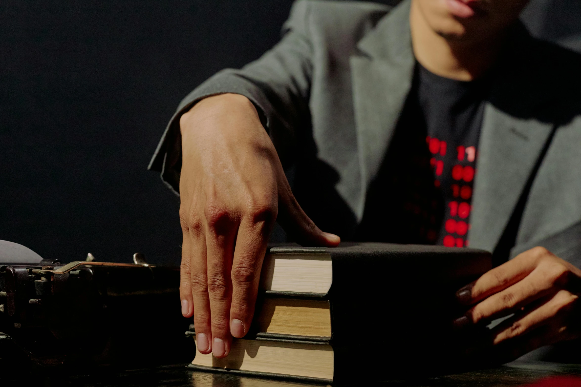 the man in the gray shirt is reading a book