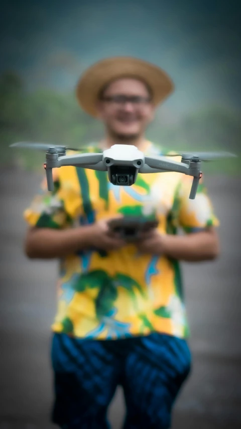 a person wearing a hat holds a remote control toy