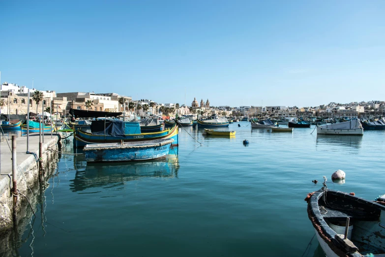 boats sitting in the water on a beautiful day