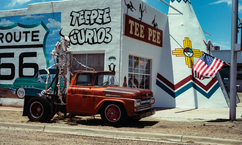 an old truck sits outside of a business