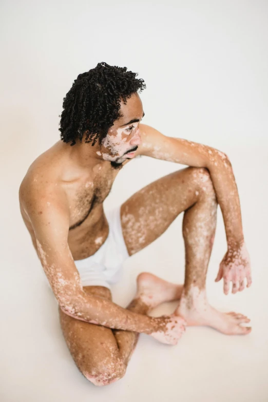 a man is sitting in the middle of smeared