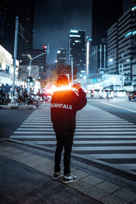 a person wearing a hoodie and lights standing on the street