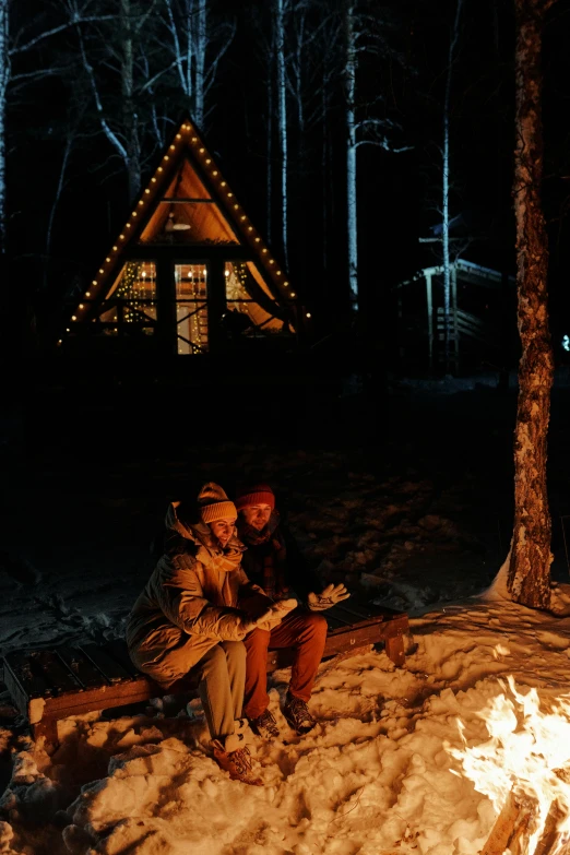 two people that are outside of a tent