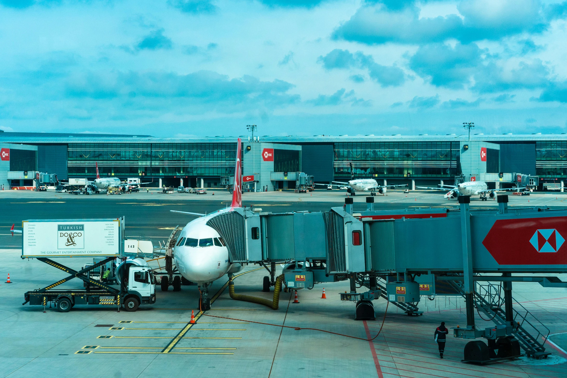 a plane being towed across a runway for passengers