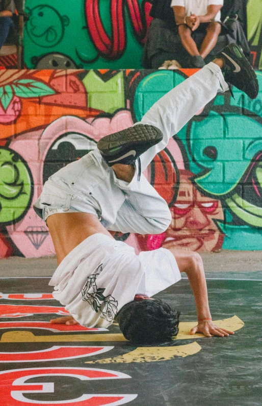 a man on his stomach and leg kicking another guy in the air