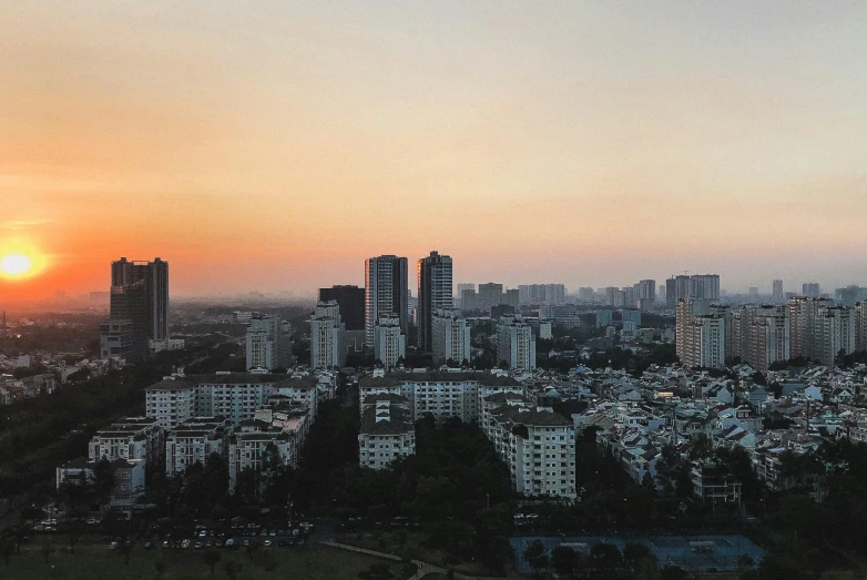 the sun is setting over a city skyline