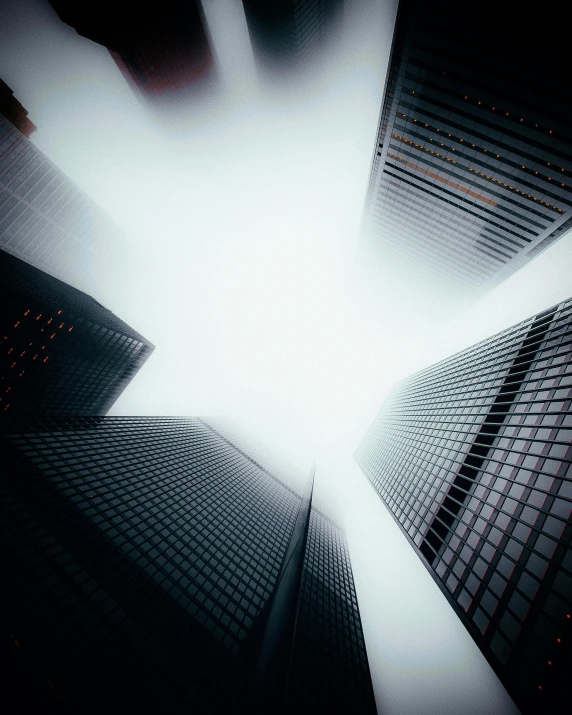 looking up at skyscrs in the middle of a city