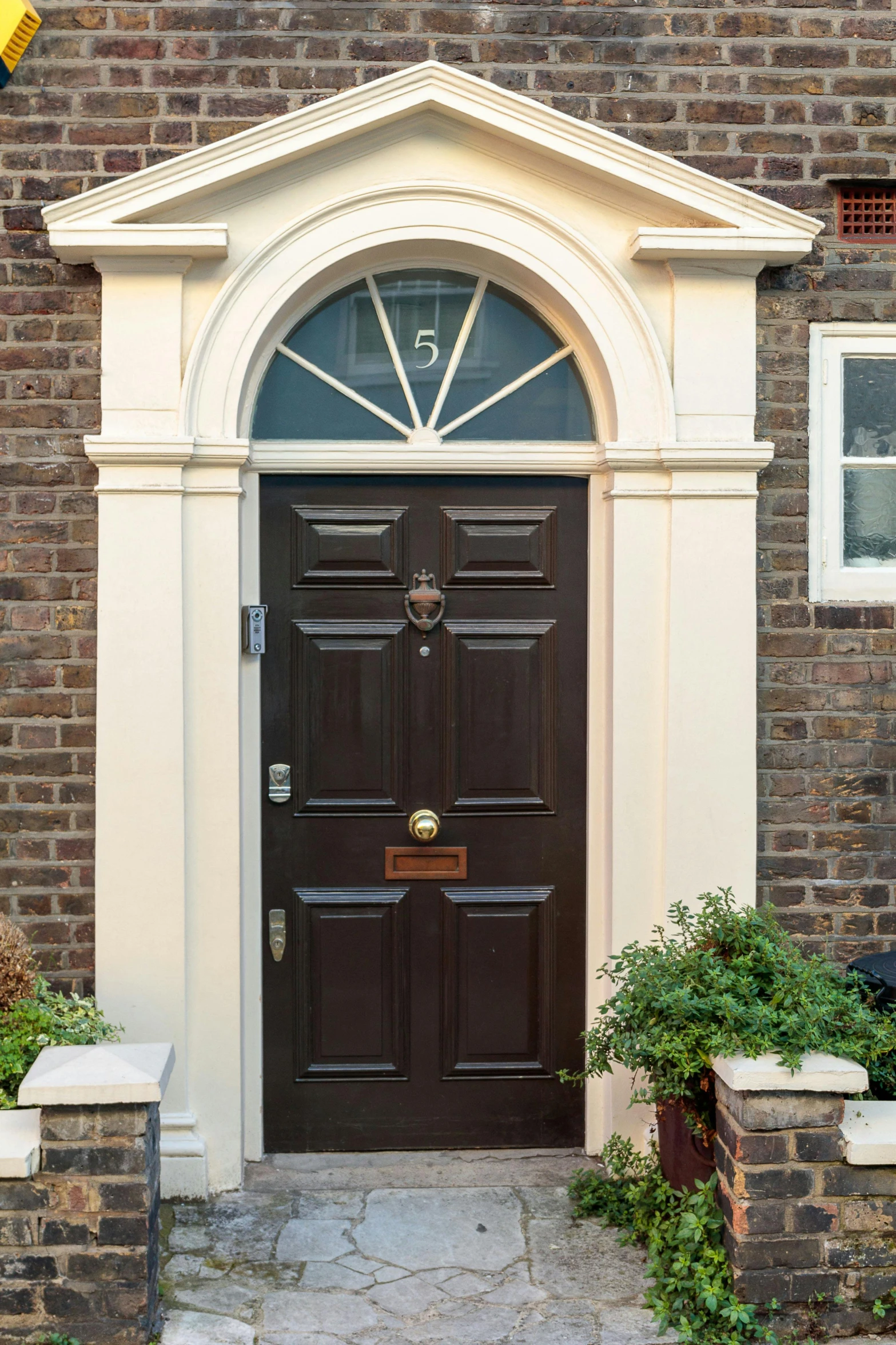 a brown door has two white arches above it