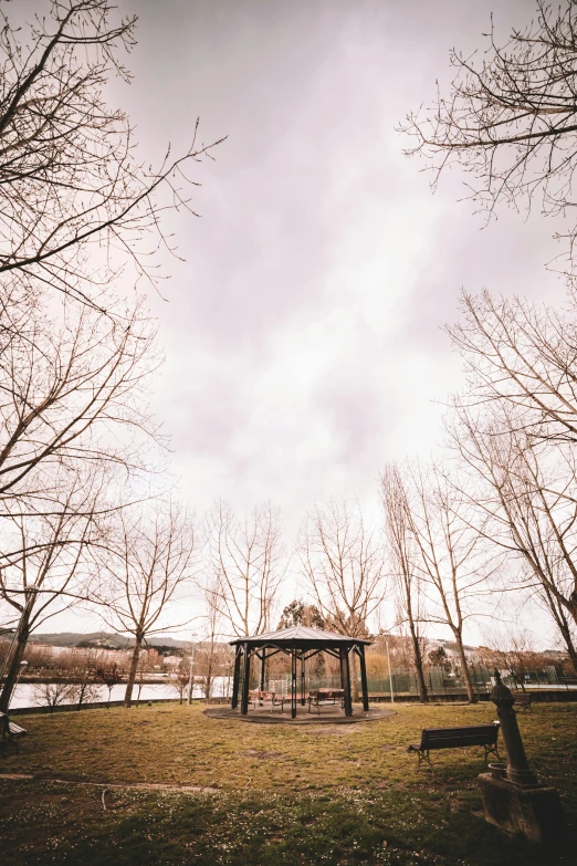 an empty park bench in front of a field