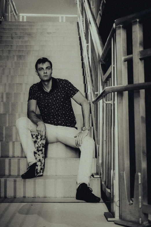 a man sitting on the steps of a staircase