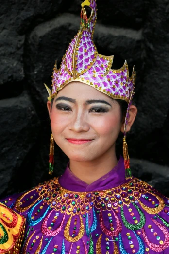 a person with a purple outfit and a gold tiara