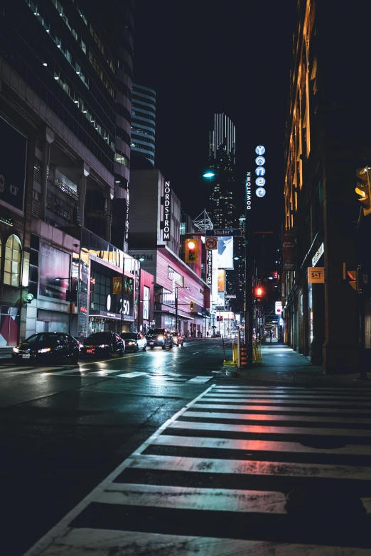 a city street with buildings lit up at night