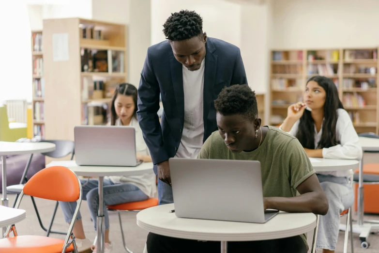 two men and a women in the liry working on their computers