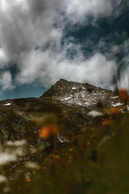 a view of a hill with a cloud in the sky