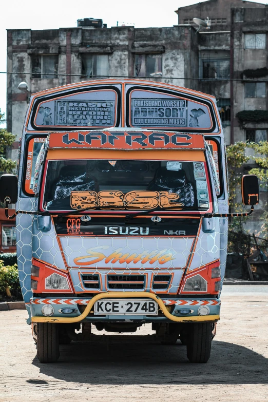 an old looking double decker bus in front of some buildings