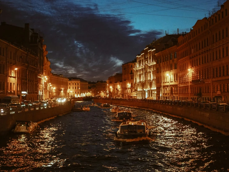 some boats on a river in front of many old buildings