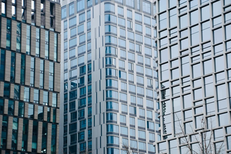 the tall buildings are reflected in the glass windows