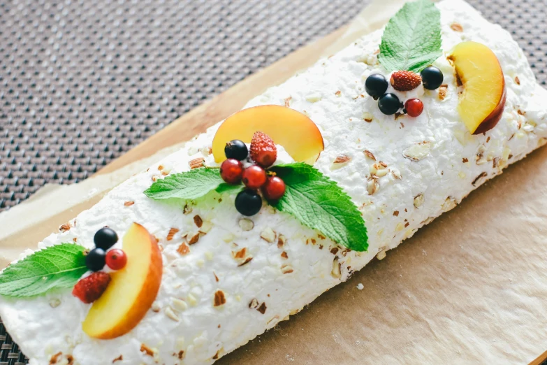 a cake covered in icing and topped with fruit