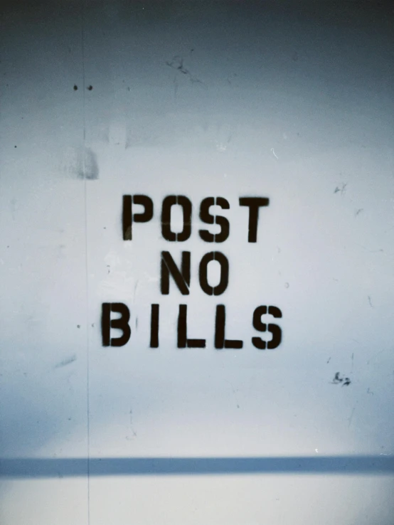 a sign that reads post no bills and black letters