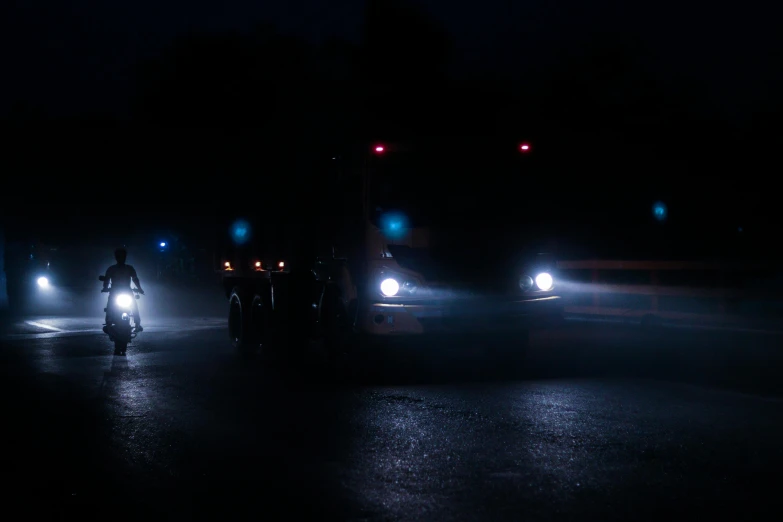 a person is riding his bike down the street at night