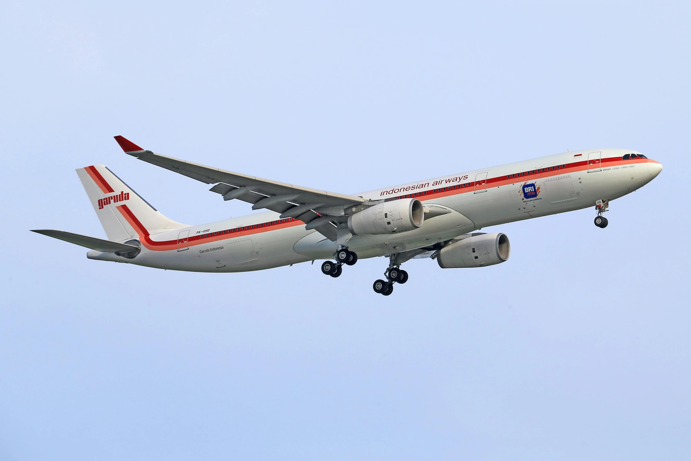 a large passenger jet flying through a blue sky