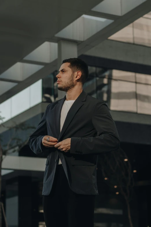 the man stands at a very tall building