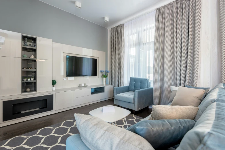 a large living room with a blue couch