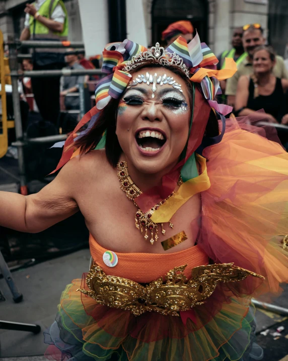 a person in a colorful costume holding a drink