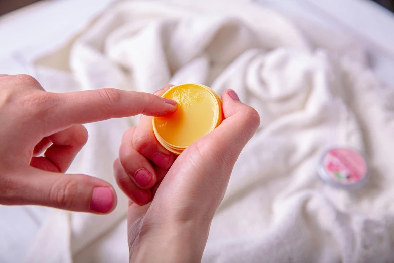 the woman is putting an orange in her cup