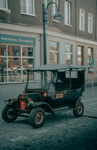 an old car that is parked near a pole