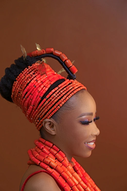 a woman with an elaborate headpiece standing by herself