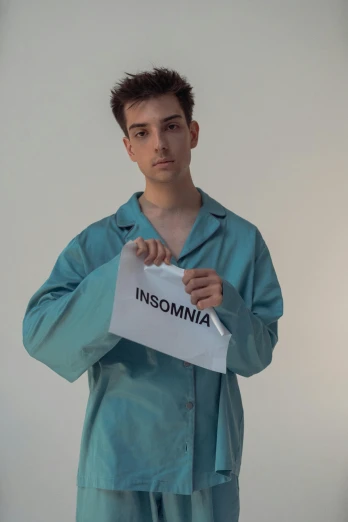 a boy with a sign that reads insomnia