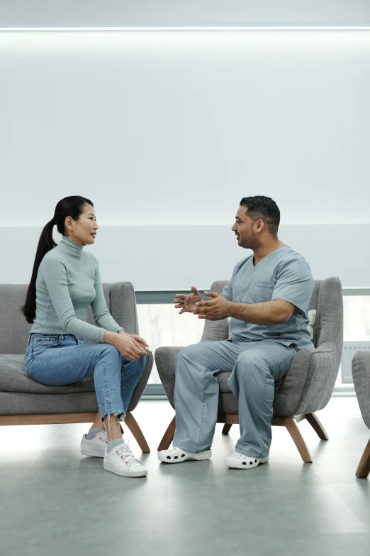 a man and woman talking sitting in a waiting room