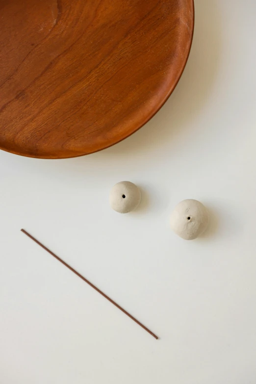 three stones and an acupress with a wooden plate