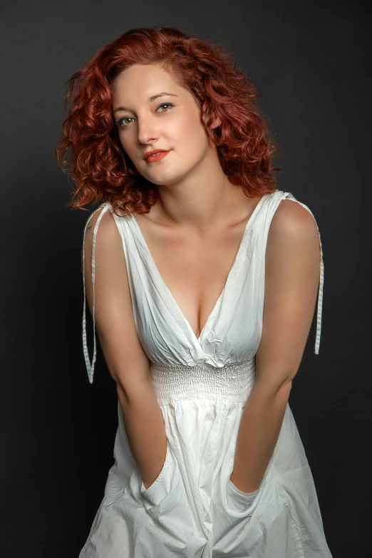 a woman in white dress with red hair