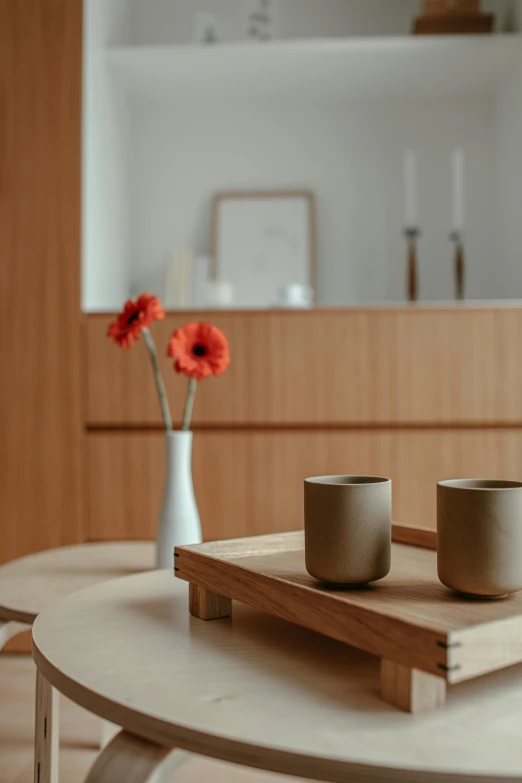 two mugs and a vase on a table in the living room